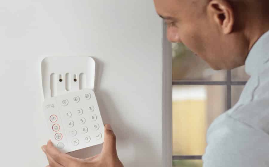 man installing the ring keypad on a wall