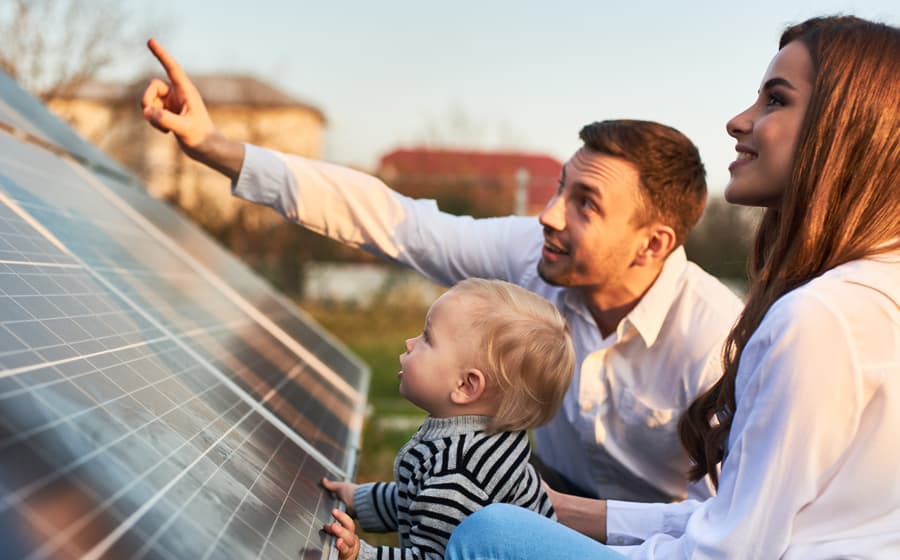 family looking at a solar panel